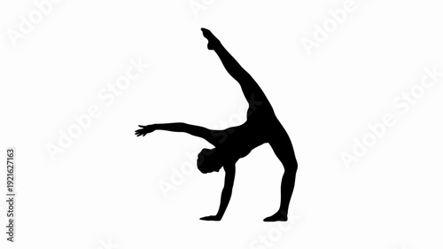 Silhouette of Grace: An elegant dancer strikes a pose, showcasing flexibility and skill in a striking silhouette that highlights the beauty of movement.