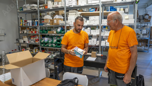 Wallpaper Mural Team of employees picking mechanical components in organized industrial warehouse Torontodigital.ca