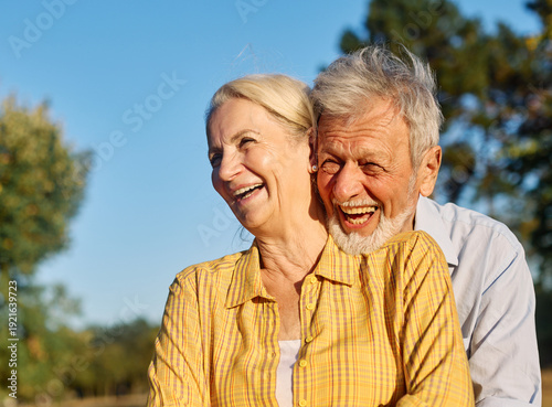 Wallpaper Mural Happy active senior couple having fun talking and hugging in park outdoors Torontodigital.ca