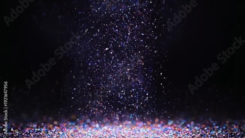 Sparkling Glitter Falling Down Against Black Background.