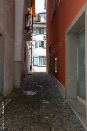 Quiet streets in the old town of Zug with historic buildings lined up along ancient city walls, empty alleys creating a calm and timeless atmosphere.