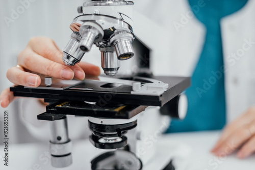 Wallpaper Mural Laboratory specialist examining samples under microscope within biosecurity global health preparedness framework focusing on pathogen detection risk monitoring and resilient medical systems Torontodigital.ca