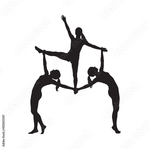 Three figures create a human pyramid in a striking silhouette