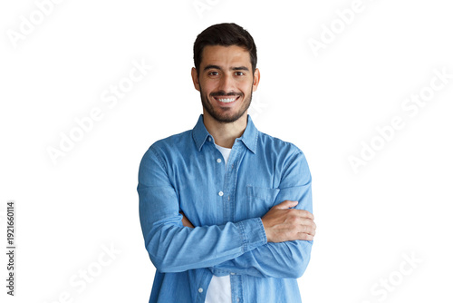 Fotografie Confident young man in blue denim shirt standing with arms crossed and smiling b