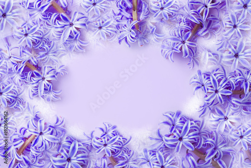 A lilac-blue background frame with spring flowers.