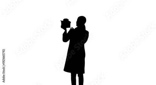 Silhouette of a person holding a camera, poised to capture a moment