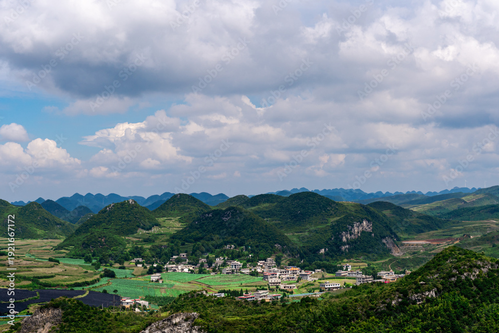 Fototapeta premium Rolling Green Hills and Winding Roads Through Rural Mountain Valley