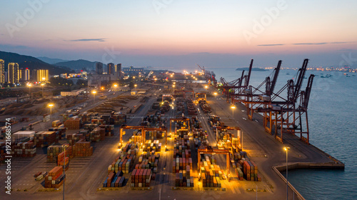 Lighted Container Harbor Port at Dusk with Industrial Cranes and Cargo