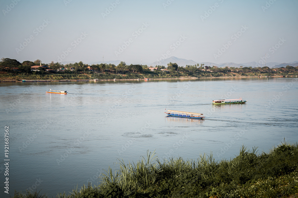 Fototapeta premium Calm river long boat water transport nature landscape travel mountain reflection rural