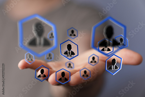 Fotografie Close up of hand holding network of people icons