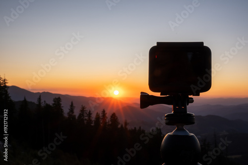 Mountain sunset Pamporovo Bulgaria layered ridges glowing summer light orange horizon GoPro silhouette foreground symbolizing travel filming capturing breathtaking nature scenic photography