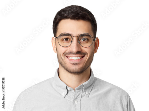 Close-up portrait of smiling young man in grey shirt wearing round metal-frame glasses