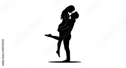 A silhouetted couple shares a passionate embrace the man lifting the woman in a romantic pose