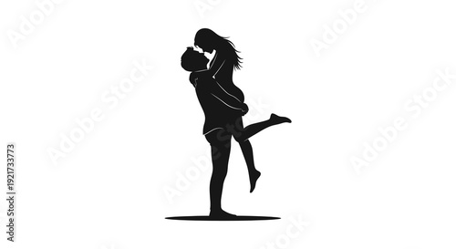 A silhouetted couple shares an intimate moment the man lifting the woman in a passionate embrace