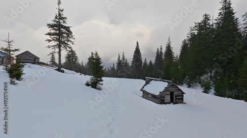 Rustic Abandoned Cabins in Snowy Mountain Landscape