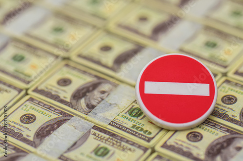 Red Prohibited Symbol on Hundred Dollar Bills Representing Financial Restriction