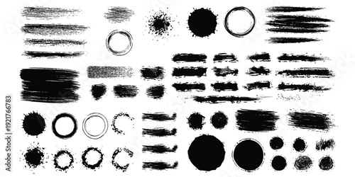 A collection of black grunge brush strokes, ink splatters, and distressed elements on a white background
