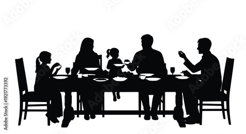 Family gathered around a dining table enjoying a meal silhouette