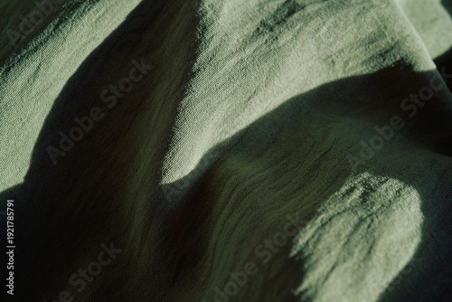 Billede på lærred Olive green fabric texture casting shadows background