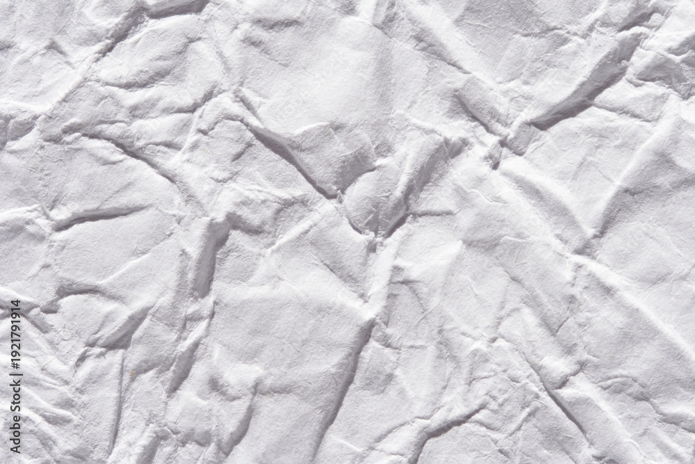 Fototapeta premium White crumpled paper texture with wrinkles for design background and creative textural concepts.