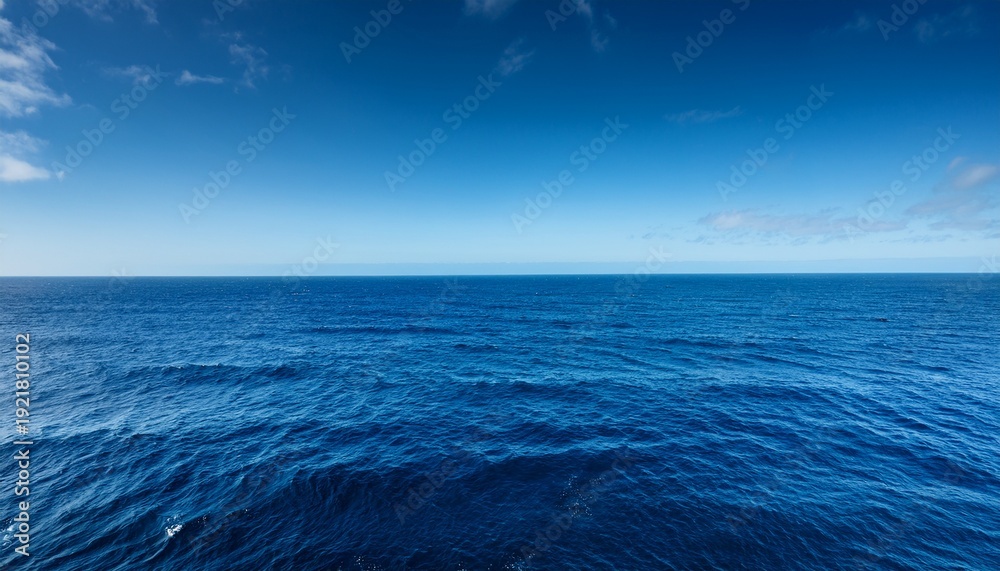 Fototapeta premium vast deep blue ocean stretches to the horizon waves gently rolling under a clear sky perfect for travel nature and serenity themes an endless expanse of calming blue marine serenity