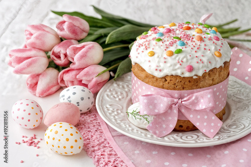 Easter cupcake with white icing, pink bow, pink eggs, tulips