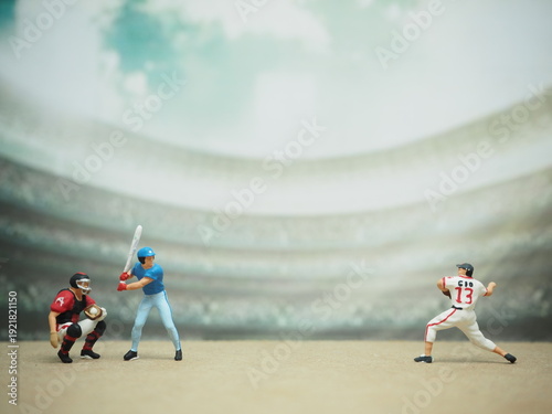 Mini toy of action figure at table with blurred background. Macro toy photography concept design. Minifigure of baseball player character.