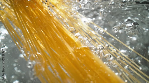 Cooking Spaghetti: Long Strands of Pasta are Dropped into a Pot of Boiling Water - View from Below the Water's Surface, Slow Motion