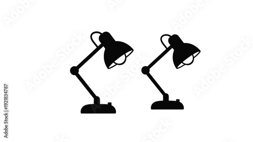 Two black desk lamps presented in a stark graphic silhouette