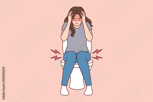 Young woman on toilet holding head due to medical issues. Concept of hemorrhoids, diarrhea, cystitis, and constipation. Suffering from stomach ache and digestive discomfort.