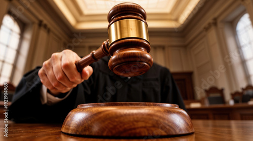 Judge's gavel striking block in courtroom during verdict