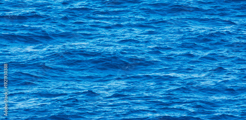 Blue ocean water surface texture with small waves natural sea background