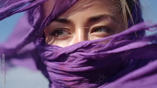 Close-up of a woman wearing a purple scarf fluttering in the wind, hope and empowerment for International Womena??s Day, 8k, realistic, full ultra HD, high resolution, cinematic photography