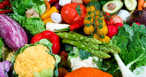 Fresh vegetables on display at a market showing a variety of colors and shapes during a sunny afternoon