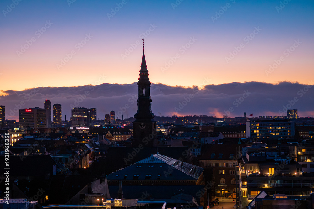 Naklejka premium Copenhagen city skyline at twilight, aerial view of urban architecture during blue hour, Denmark.