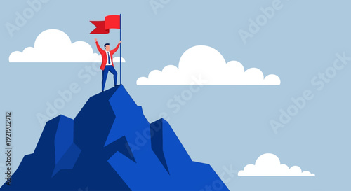 Triumphant person standing on mountain peak holding red flag high in clear blue sky with white clouds