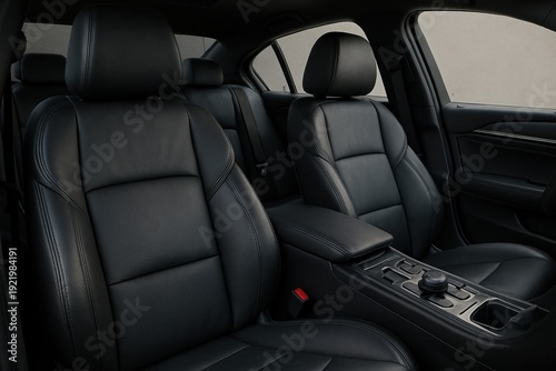 Close up of modern car interior featuring pristine black leather seats, a comfortable armrest, and a detailed center console. Ideal for automotive, travel, or luxury branding.