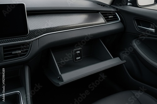 Close-up of a car's interior with an open glove compartment, showing a built-in on/off switch. Automotive technology concept, car features, vehicle details.