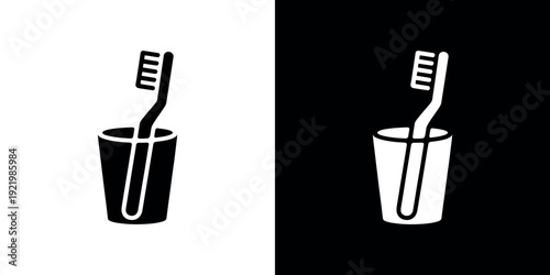 Black and white toothbrush in cup on contrasting backgrounds