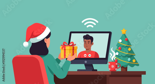 Woman wearing Santa hat makes video call on computer with gift during Christmas celebration at home office desk with decorated tree