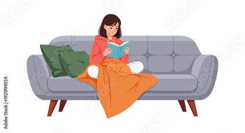 Woman reading a book on a gray sofa with pillows and blanket in a cozy living room scene