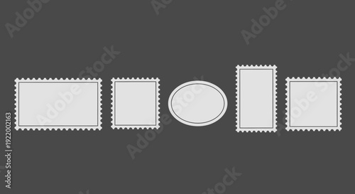 Collection of various light grey postage stamps with perforated edges on a dark background