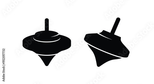 Two spinning tops depicted in a striking black silhouette