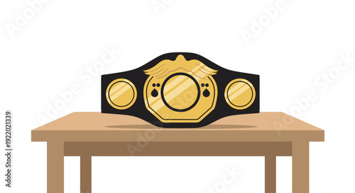 A shiny gold championship belt with a prominent circular emblem featuring an eagle design, resting securely on a light brown wooden table.