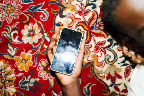 Hand holding phone with smudged screen