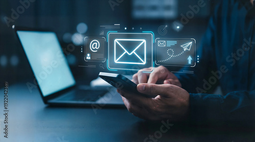 Digital marketer using email marketing tools on laptop and smartphone, sending newsletters and analyzing campaign performance to engage subscribers and grow business through personalized content