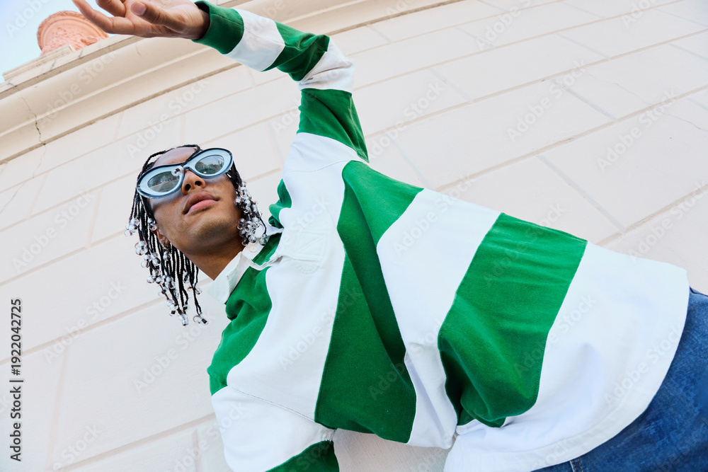 © Natalia Blauth/Stocksy - Upward Gesture in Bold Streetwear