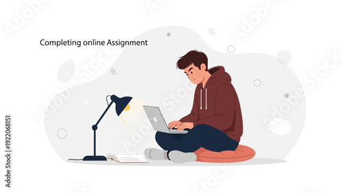 Young man working on laptop, studying online, completing assignment, desk lamp