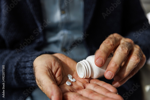 Closeup shot of senior man taking pills