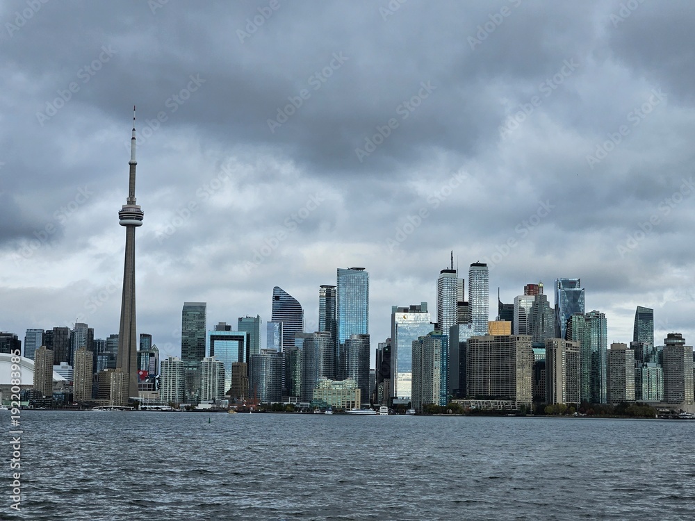 Fototapeta premium Toronto Ontario Canada - CN Tower skyline under dramatic storm clouds over Lake Ontario